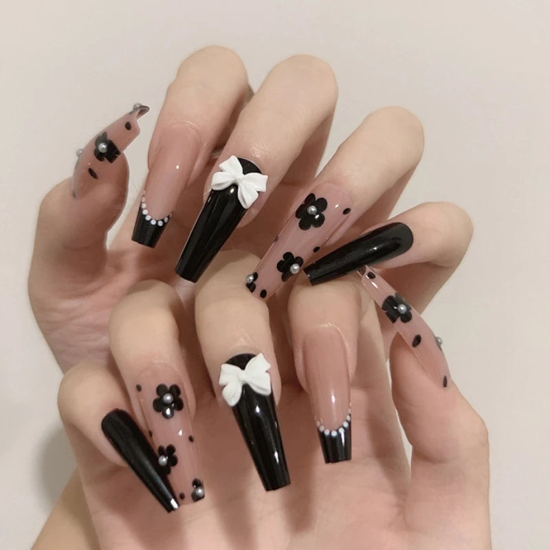 Decorated press-on nail designs shown on hands