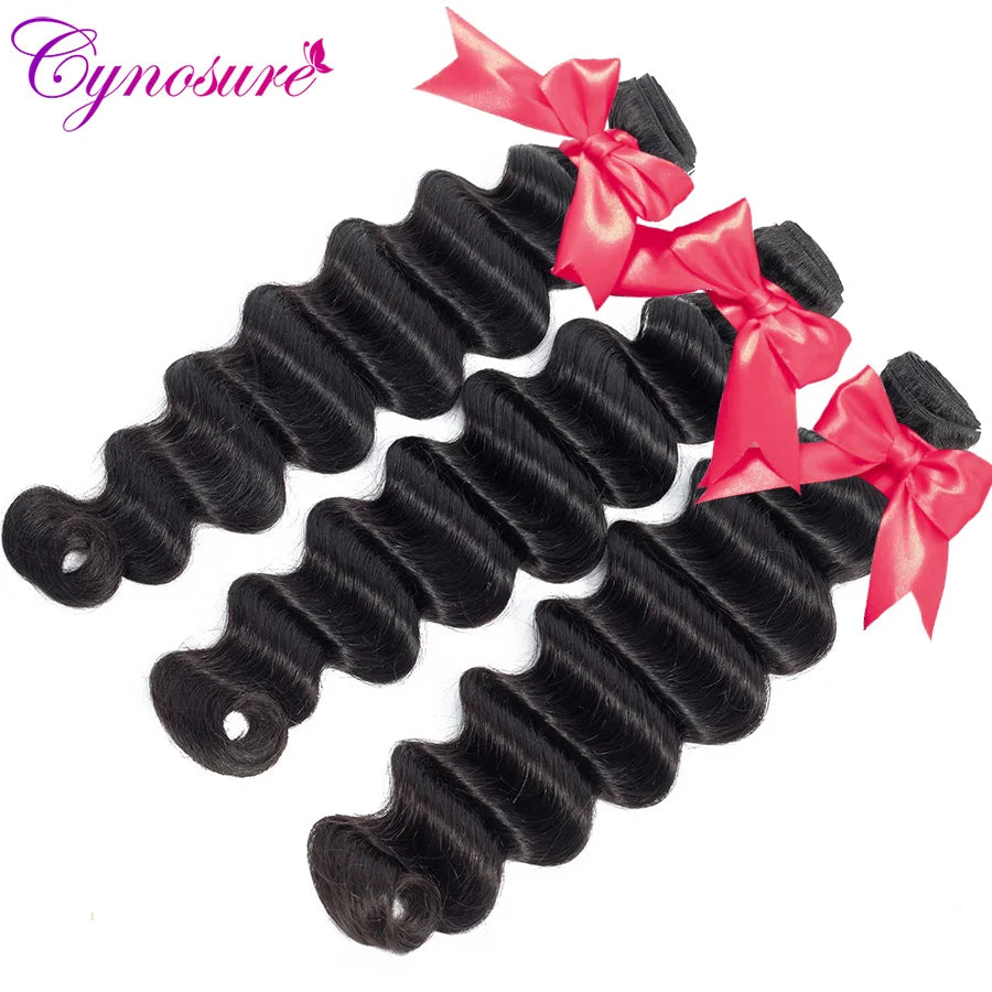 Dark wavy hair bundles tied with red ribbons