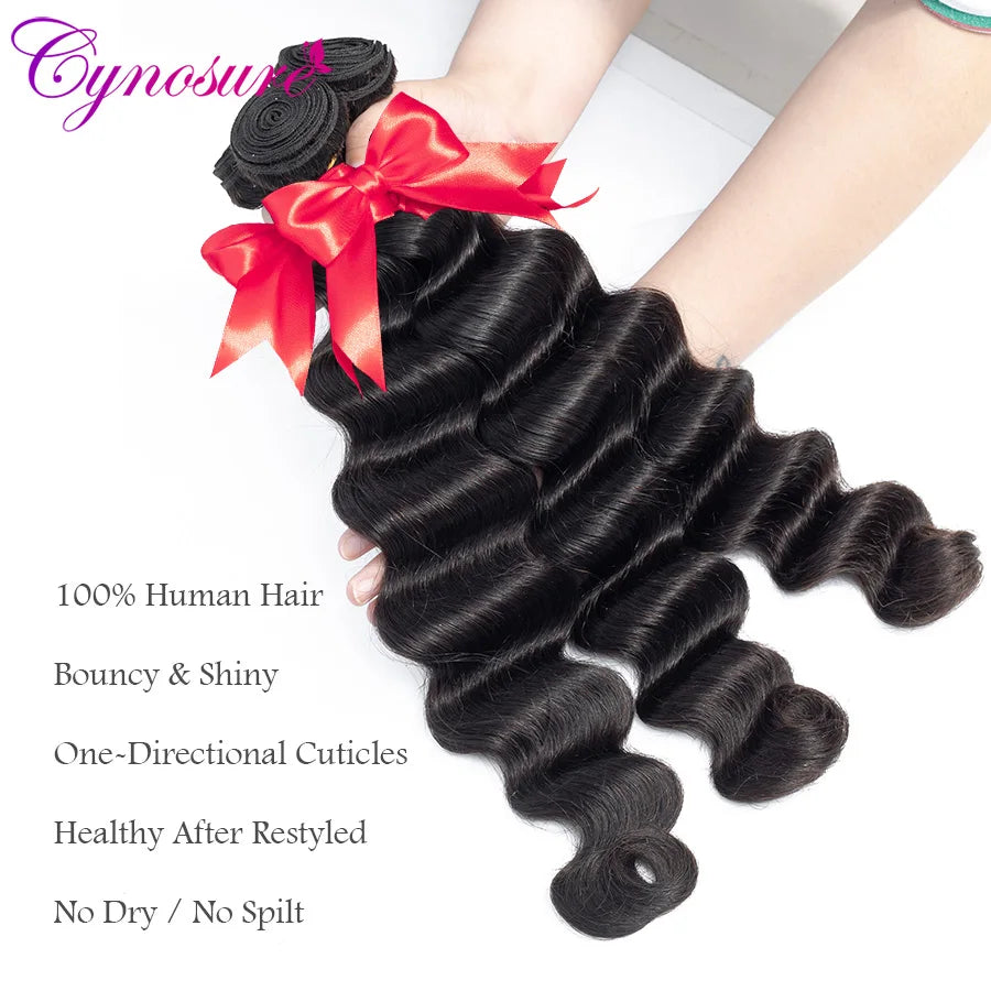 Dark wavy hair bundles tied with red ribbons