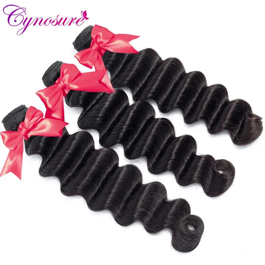 Dark wavy hair bundles tied with red ribbons