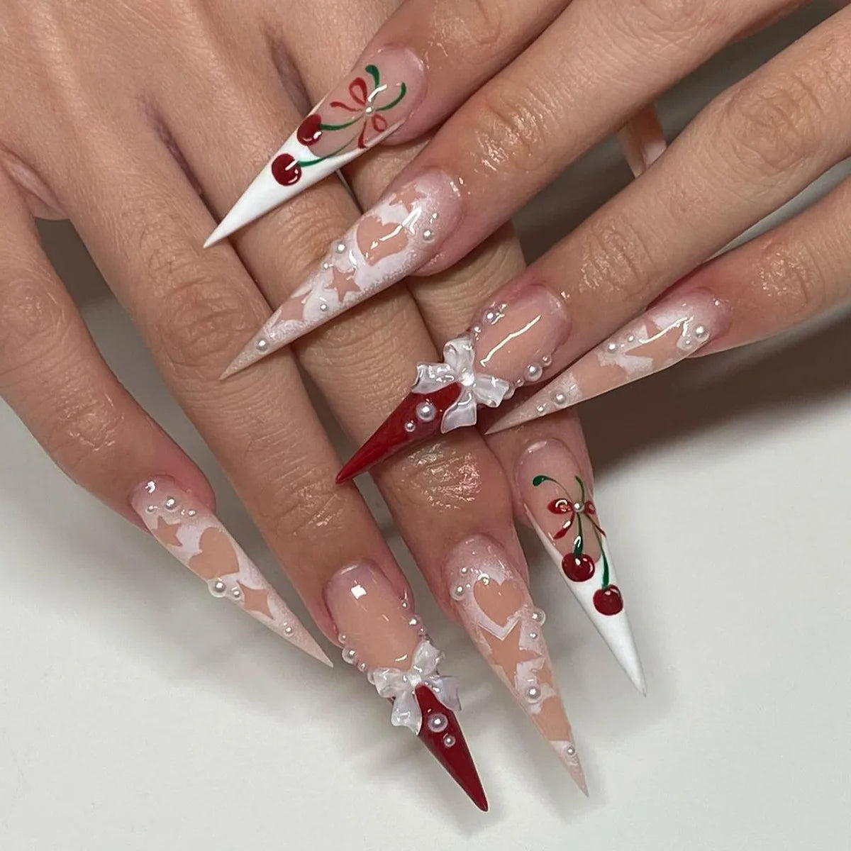 Long pointed decorative nails shown on hands