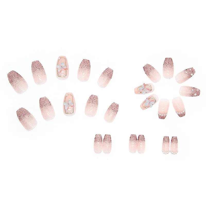 Pink decorated press-on nails arranged on a white background