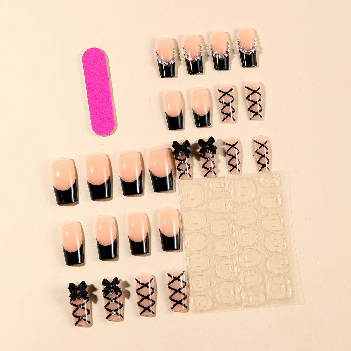 Black and nude press-on nails with decorative accents arranged as a set