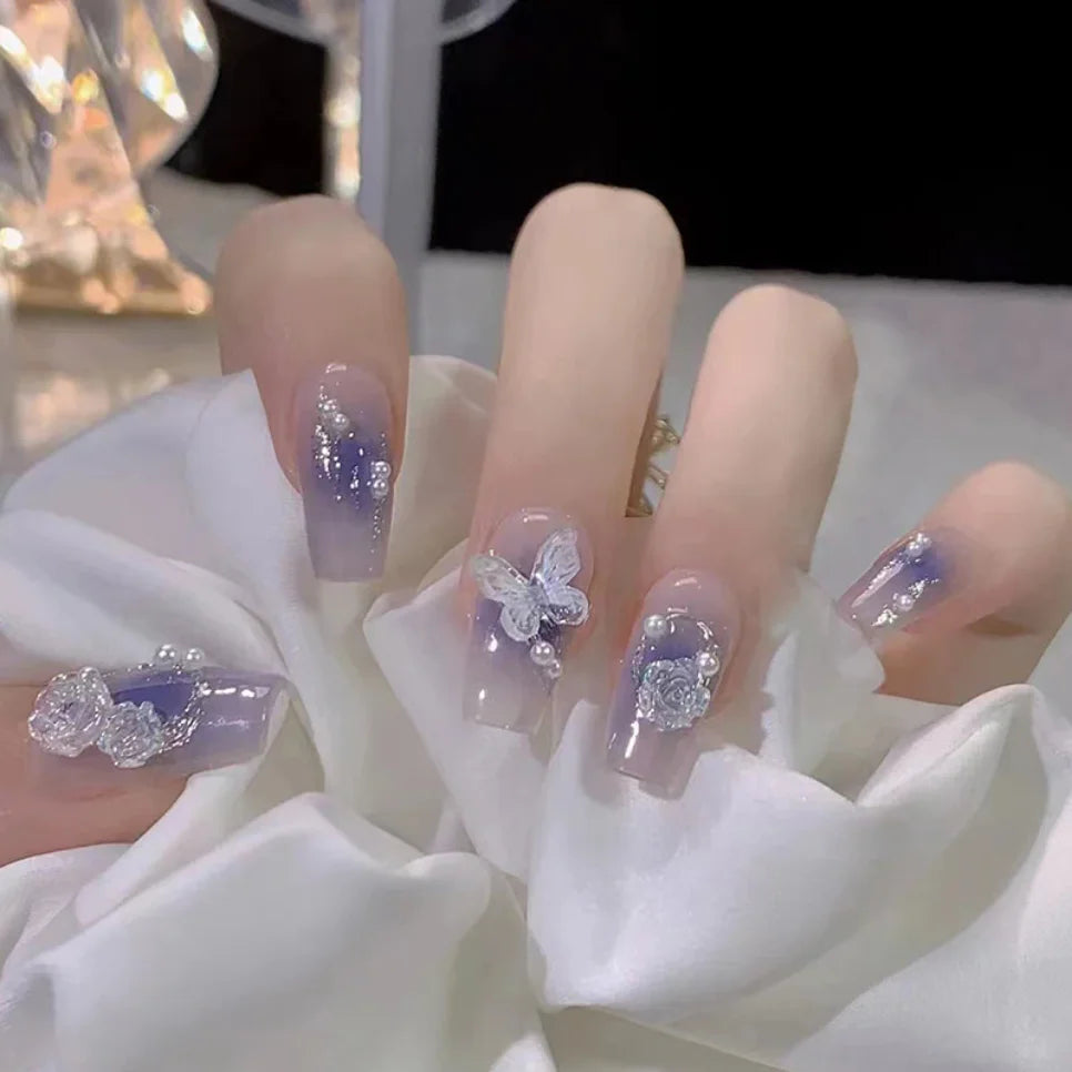 Purple decorative nails shown on a hand