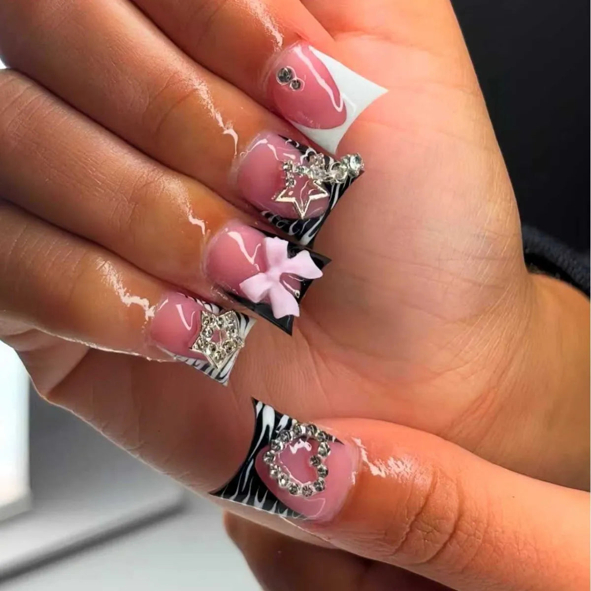 Decorative nail designs with raised accents shown on hands