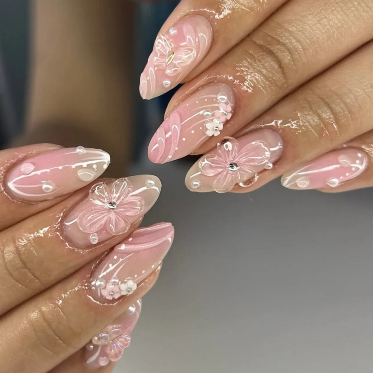 Decorated floral nails shown on hands