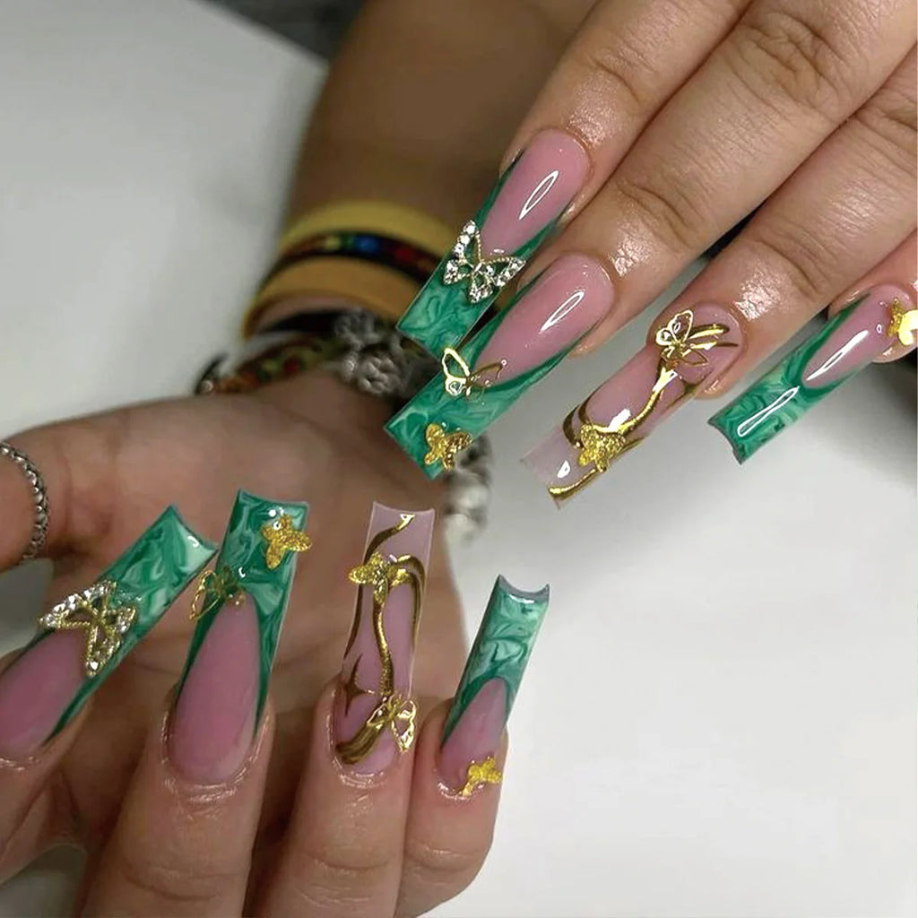 Long decorated nail designs shown on hands