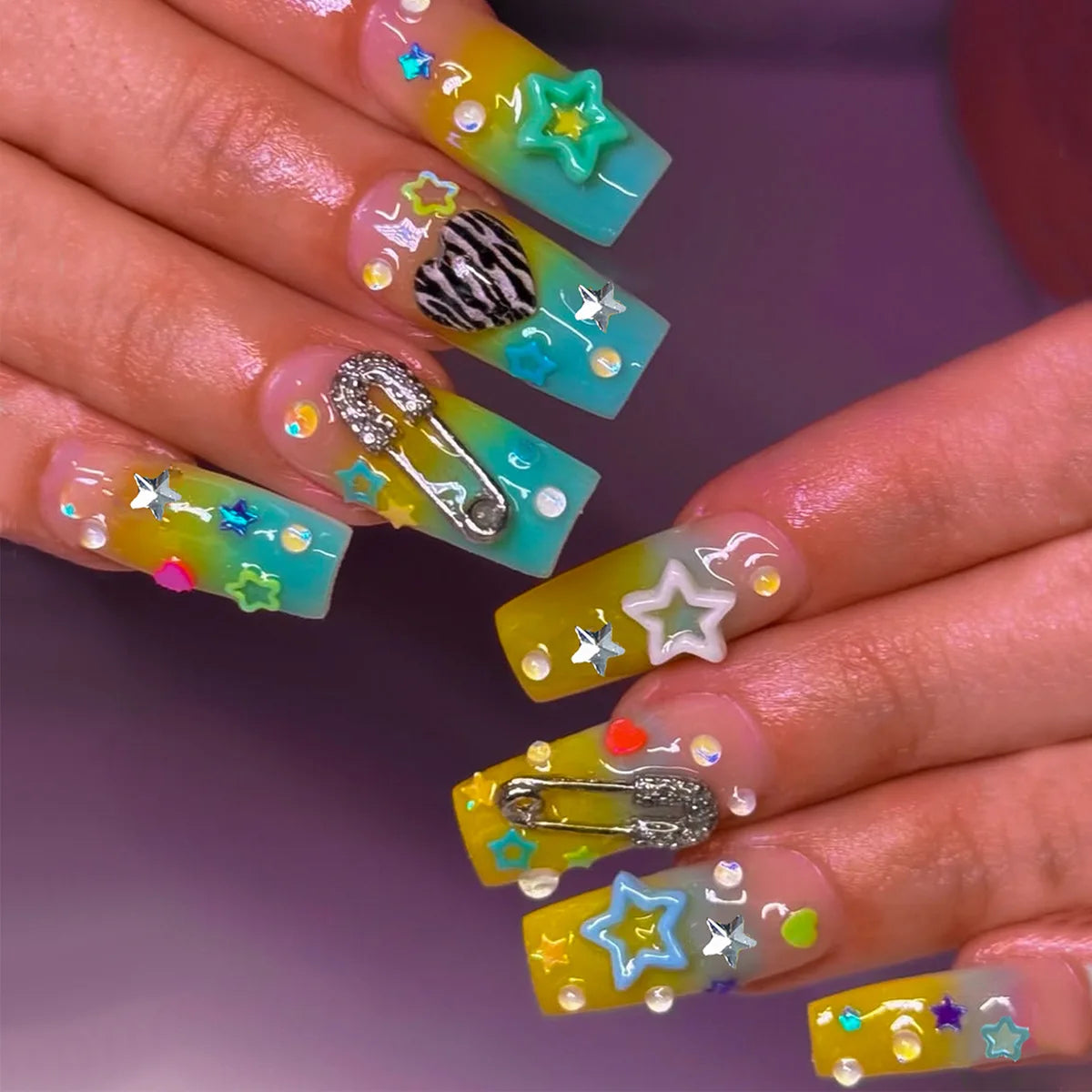 Decorated nail designs shown on hands