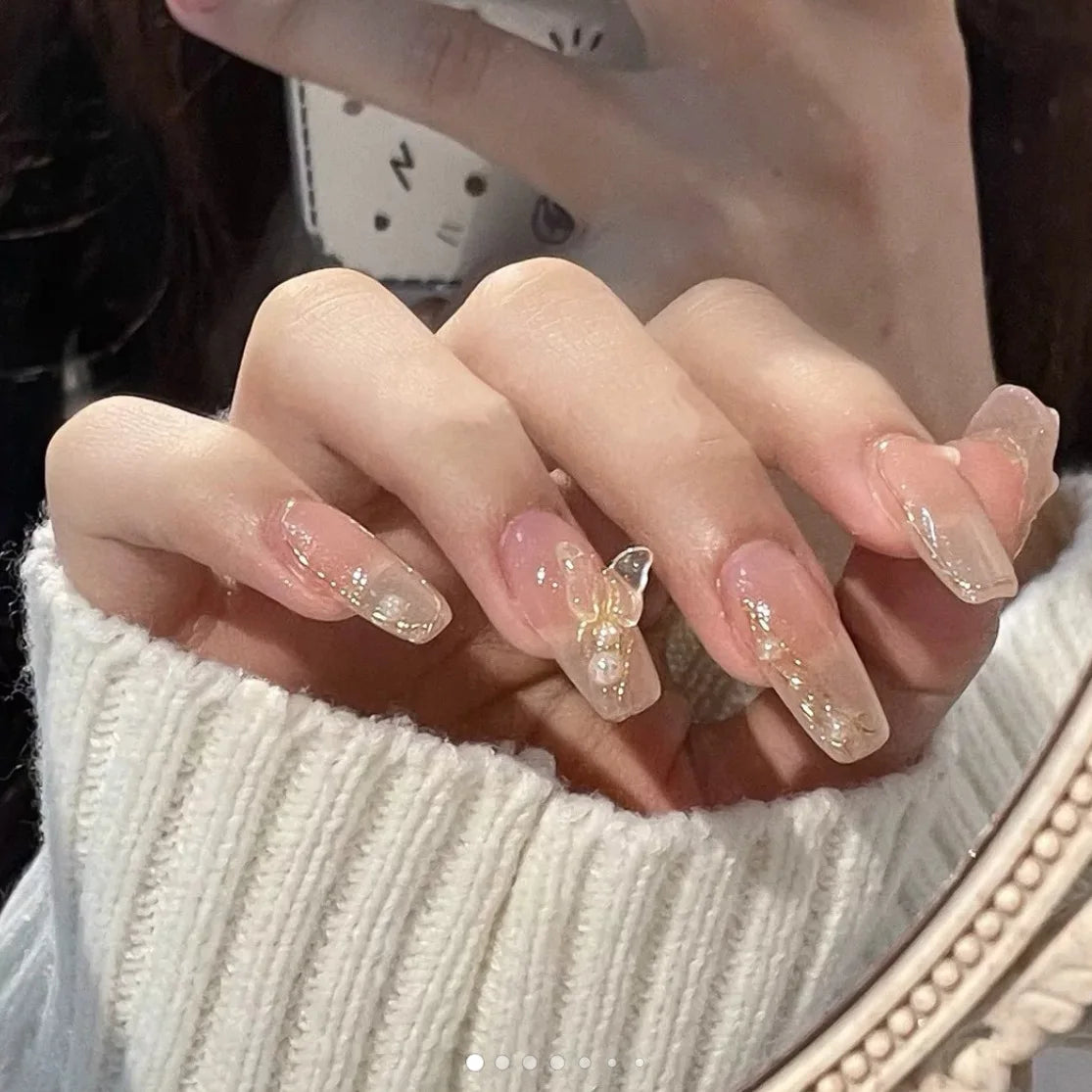 Decorated press-on nail designs shown on hands