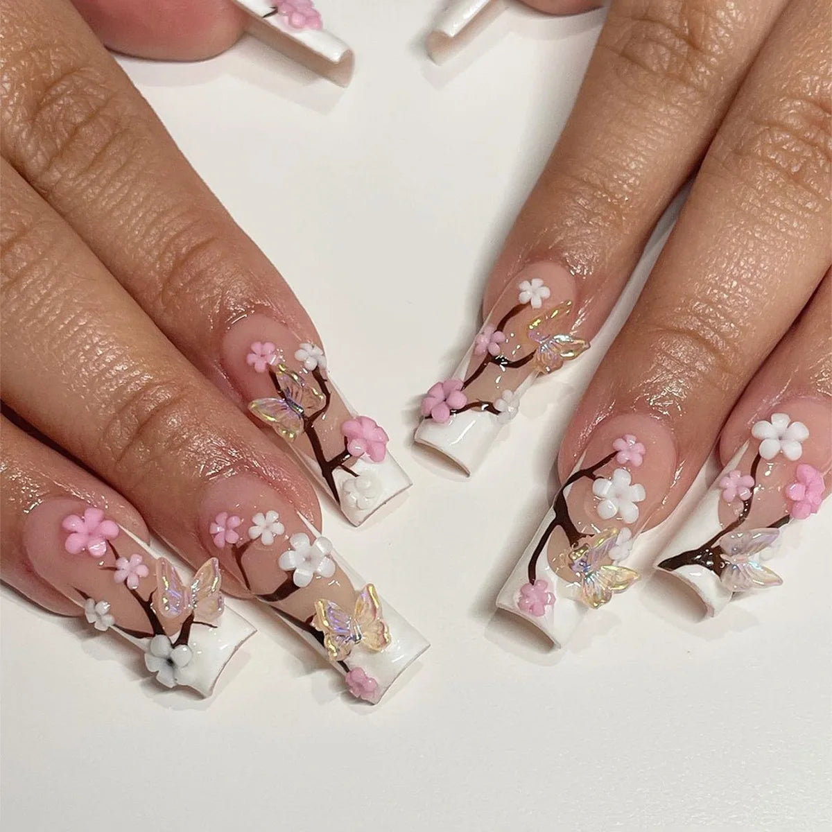 Long decorated nail designs shown on hands