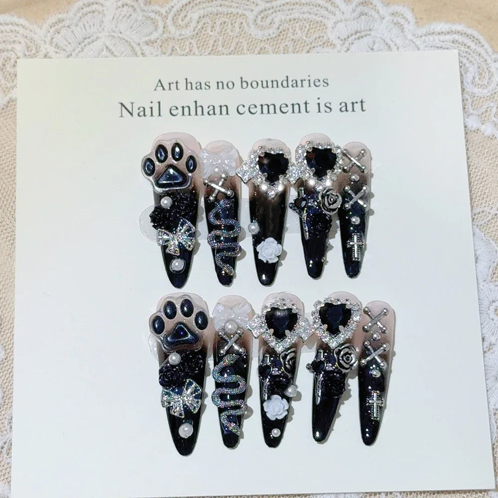 Decorated press-on nail sets with raised embellishments on display cards