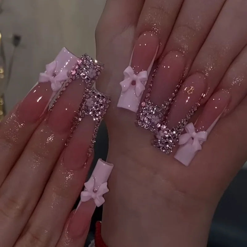 Long decorated nails with raised embellishments shown on hands