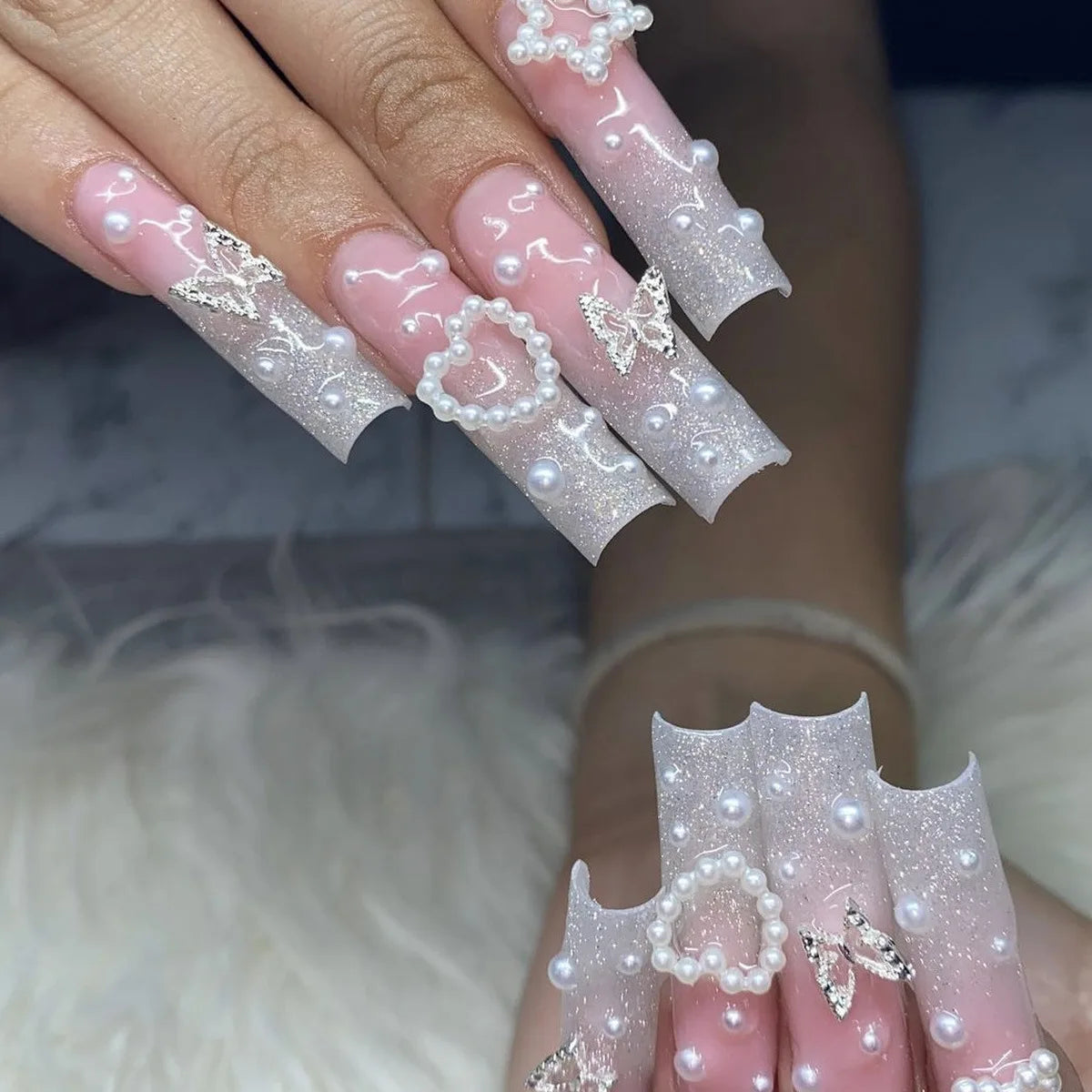 Decorated nail designs shown on hands