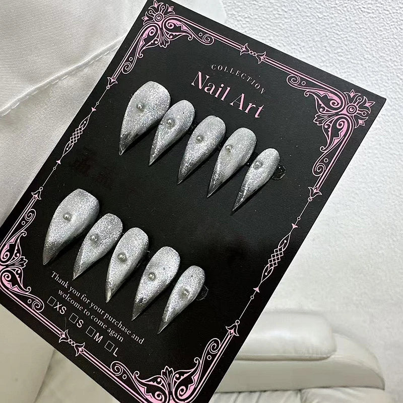 Decorated pointed press-on nails arranged in two rows
