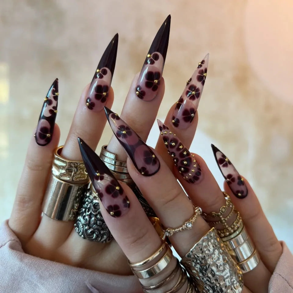 Decorated long nail designs shown on hands
