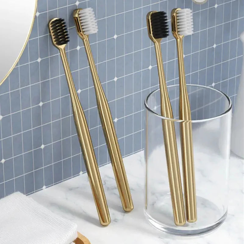 Gold and silver toothbrushes with bristle and handle details