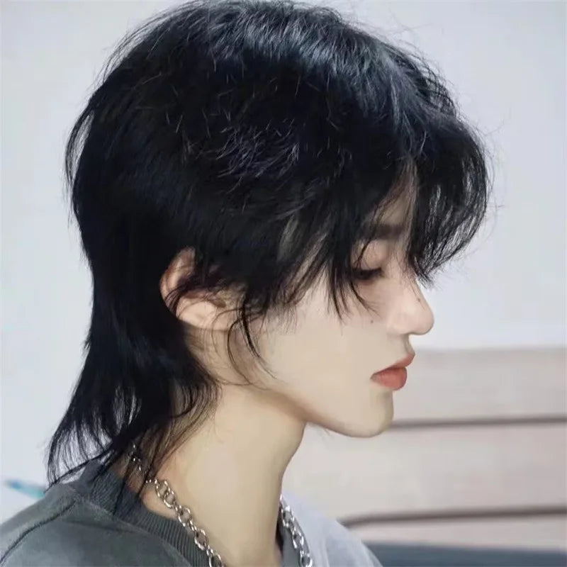 Side view of a model wearing a natural-black layered mullet wig with a long nape.