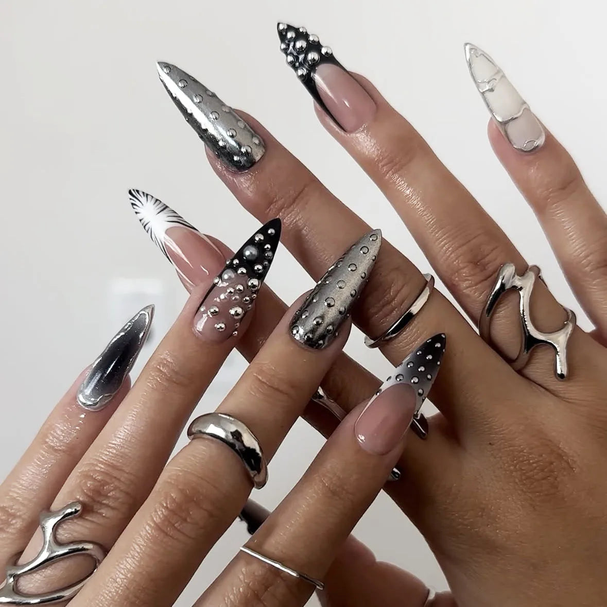 Decorated long nail designs shown on hands