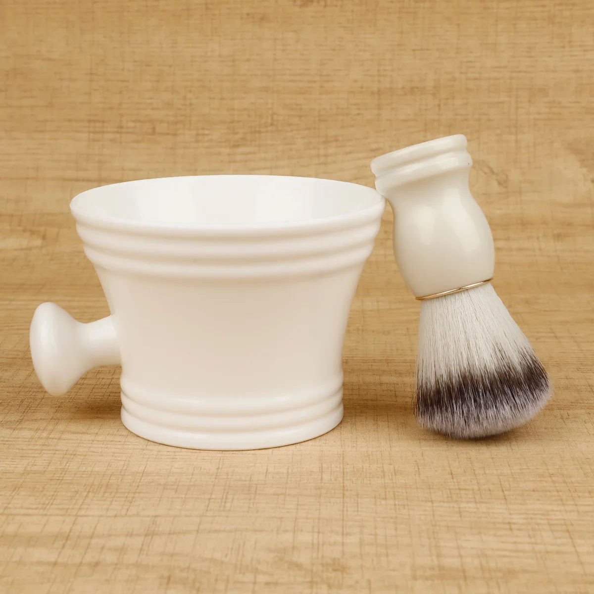 Shaving brush beside a cream-colored bowl