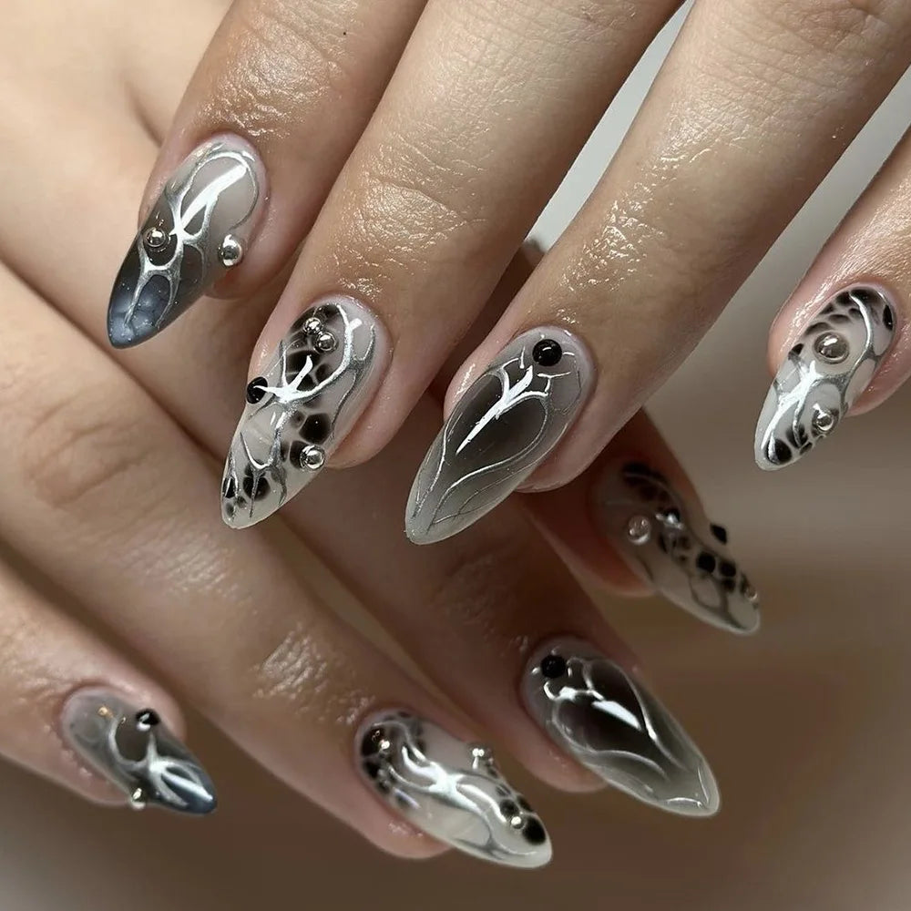 Long decorated nail designs shown on hands