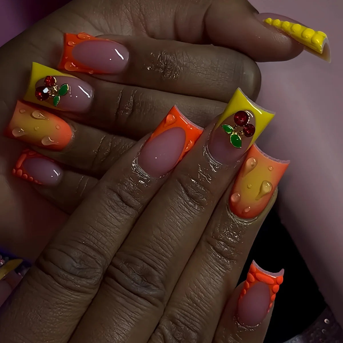 Decorative nail designs with raised accents shown on hands