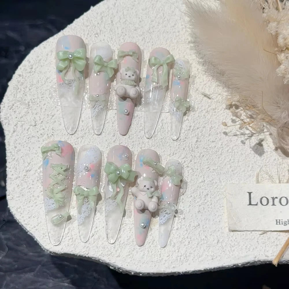 Decorated press-on nail sets with raised embellishments on display cards