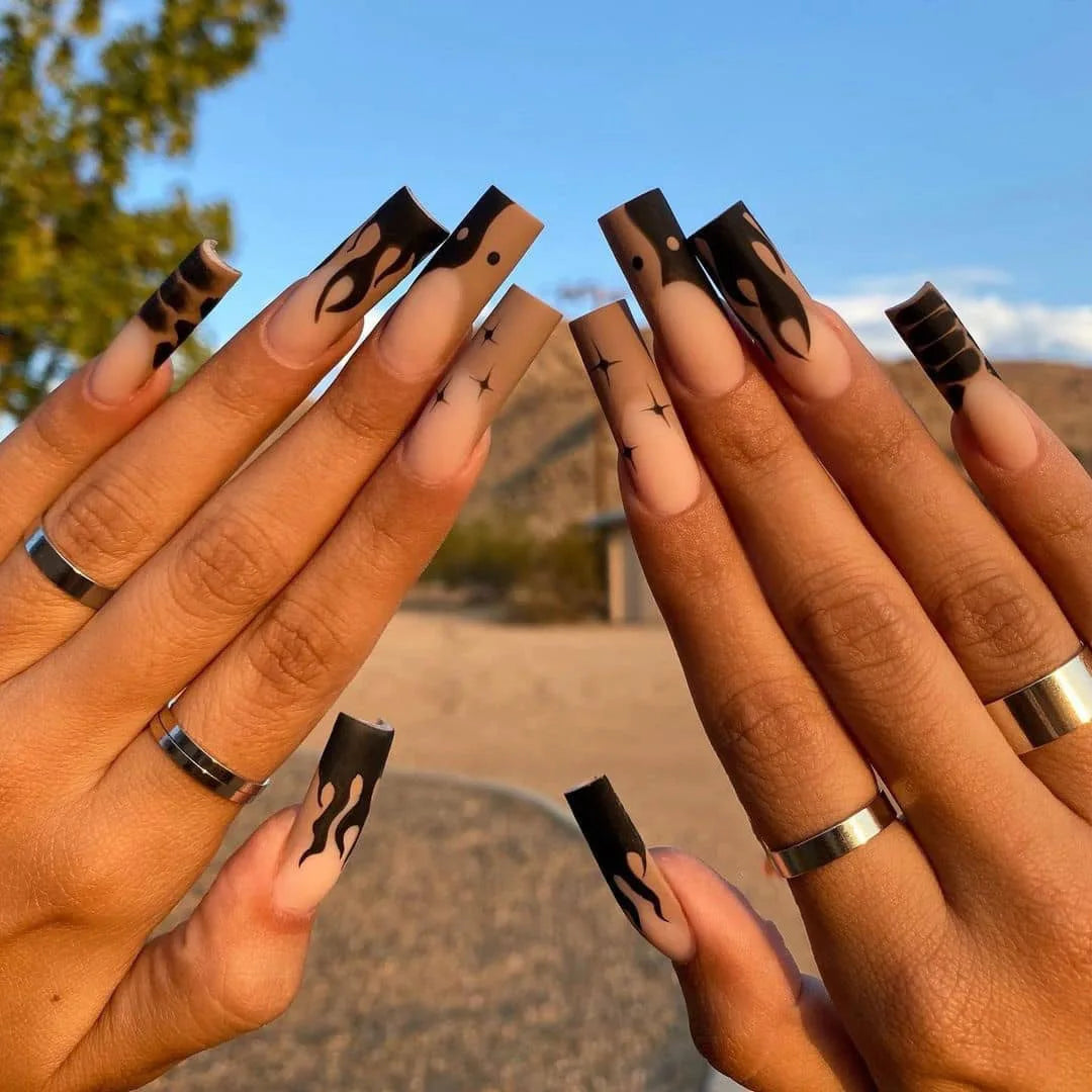 Long decorated nails with raised embellishments shown on hands