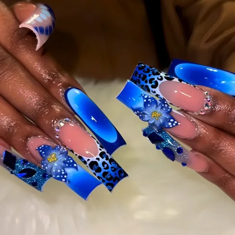 Long colorful decorated nails shown on hands