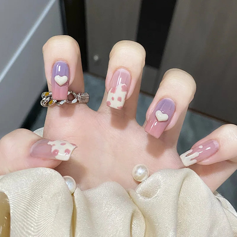 Decorated nail designs shown on hands
