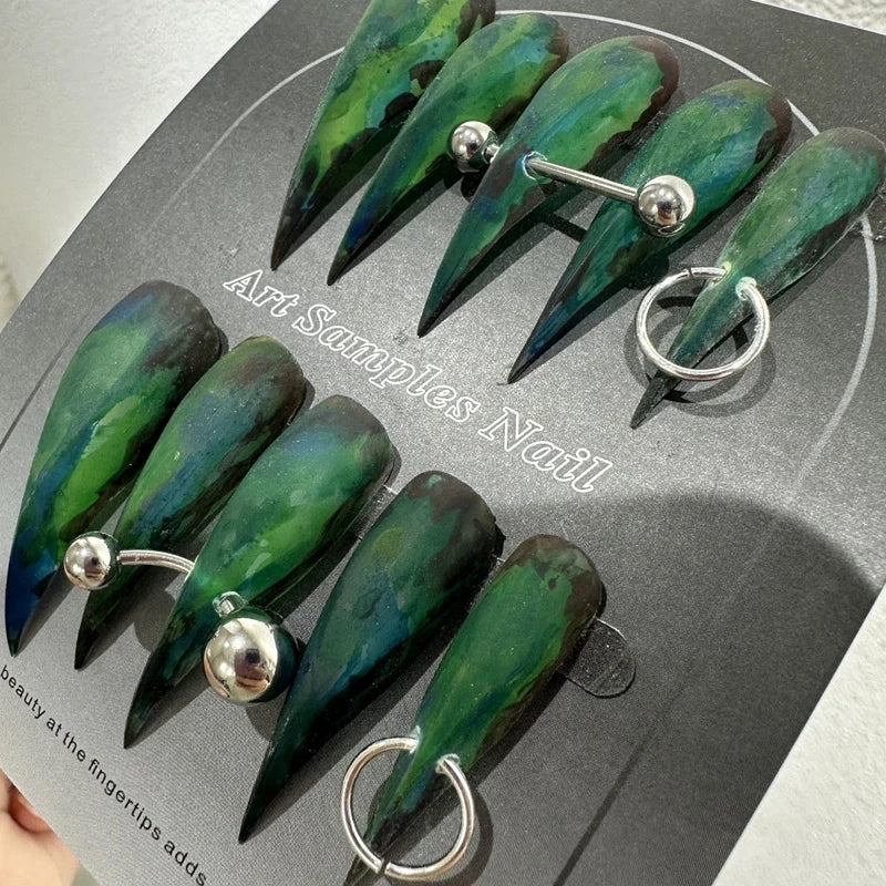 Decorated pointed press-on nails arranged in two rows