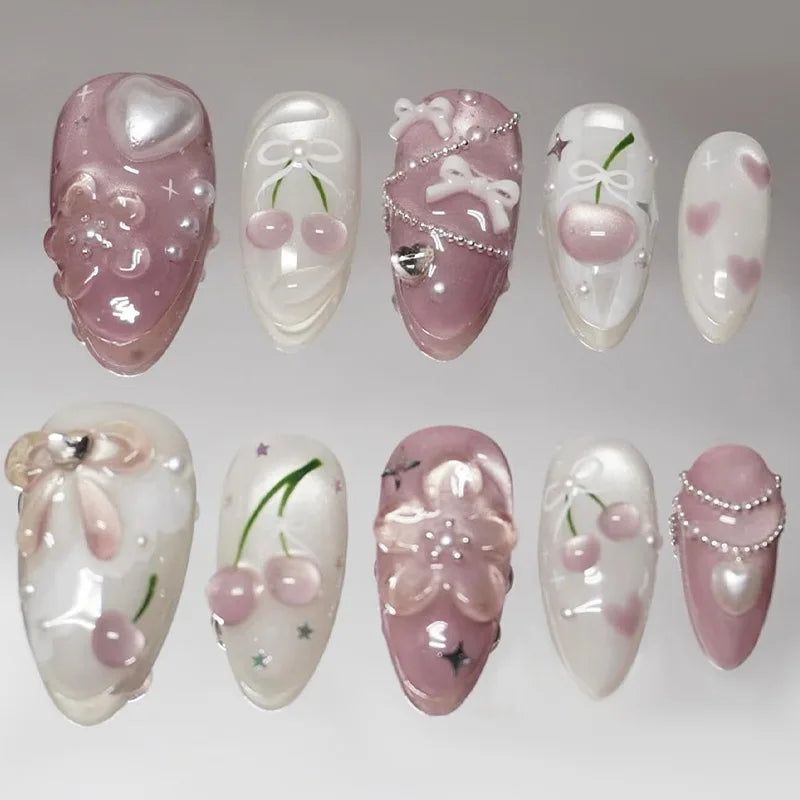Pink and white floral press-on nails arranged in two rows