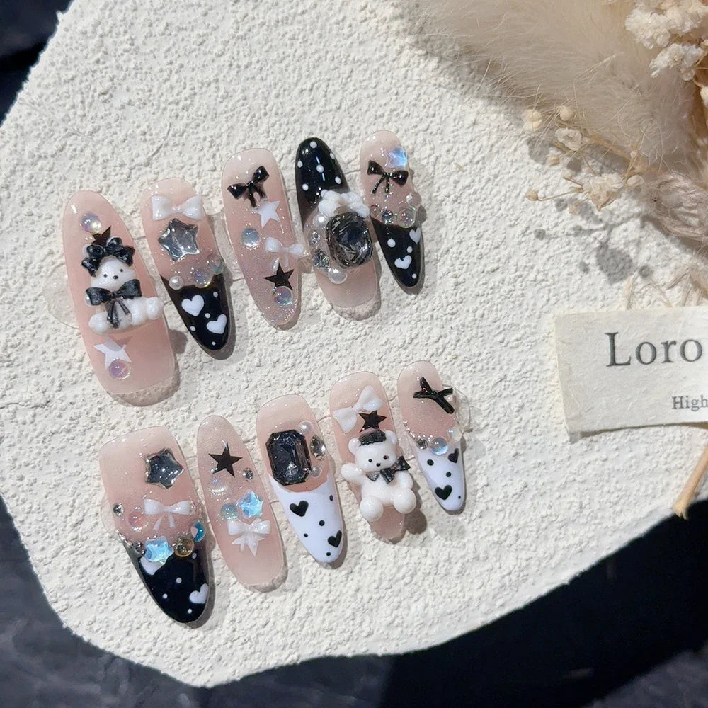 Decorated press-on nail sets with raised embellishments on display cards