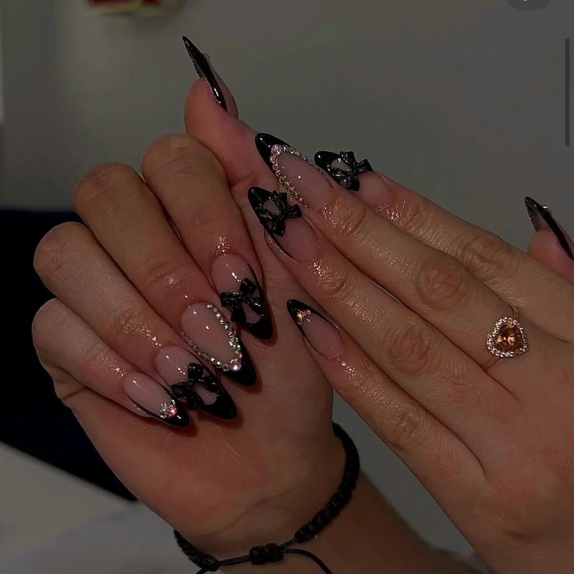 Metallic and embellished nails shown on hands