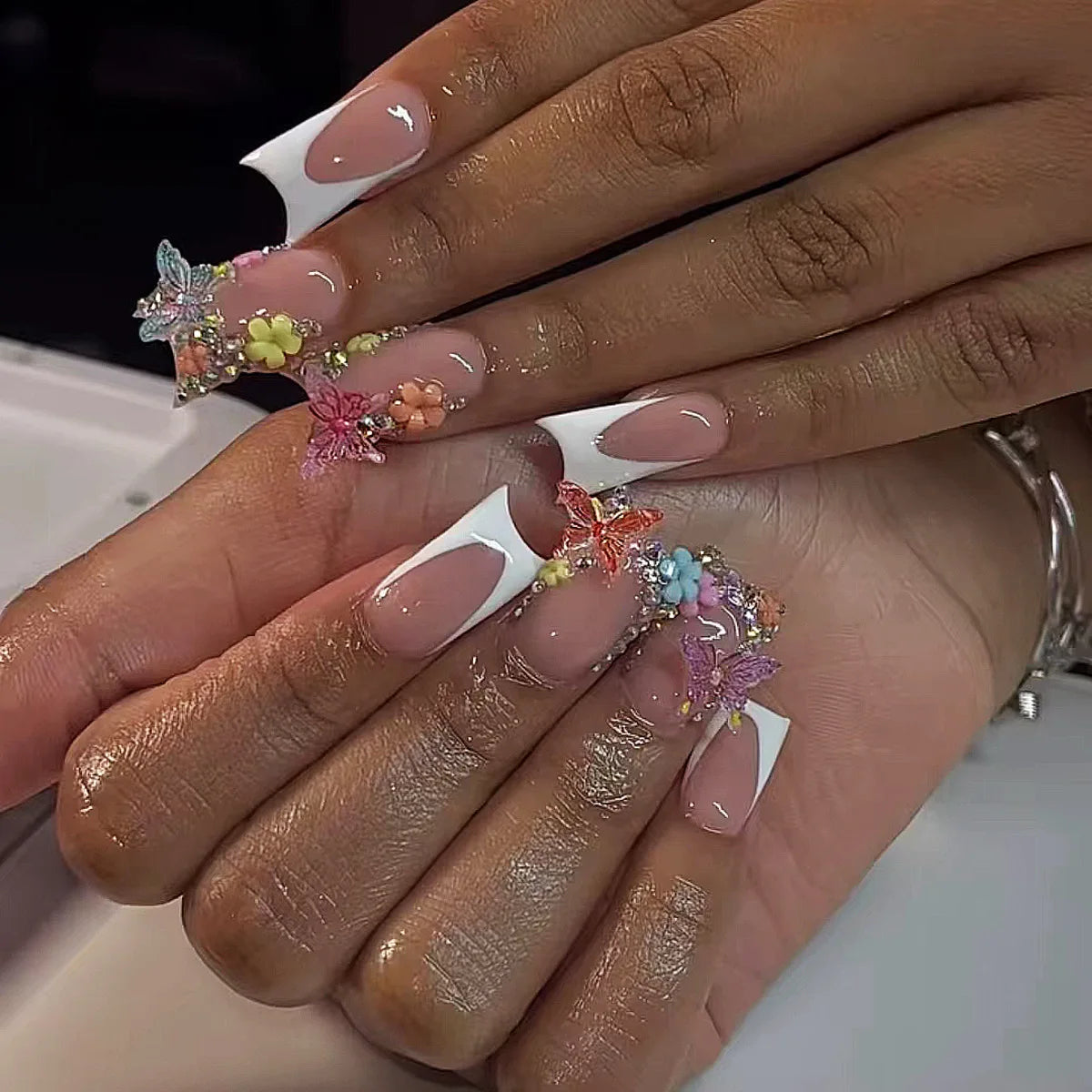 Decorative nail designs with raised accents shown on hands