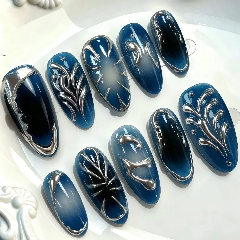 Blue and metallic press-on nails arranged in rows