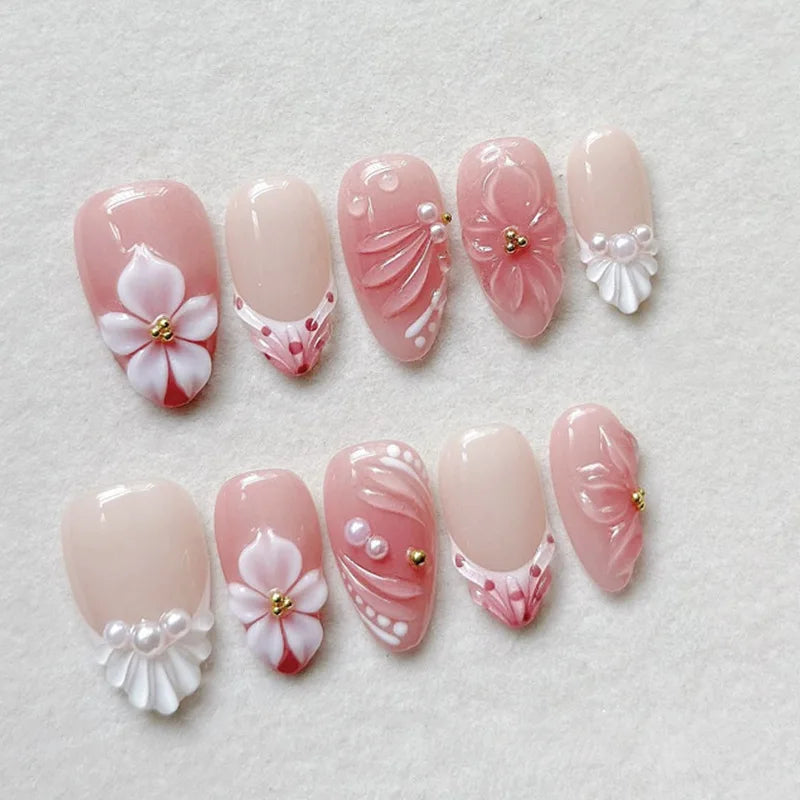 Pink floral press-on nails arranged in rows