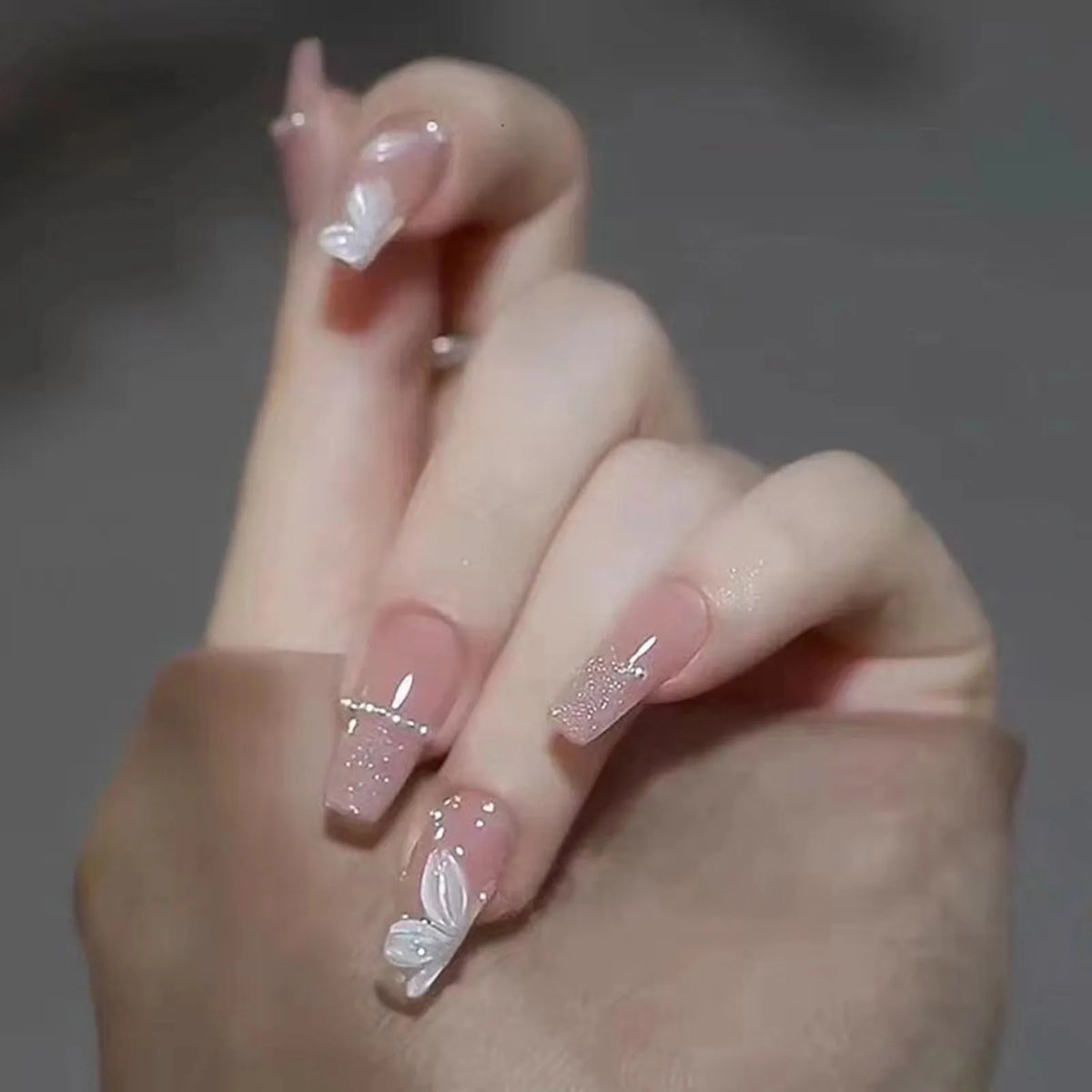 Decorated nail designs shown on a hand