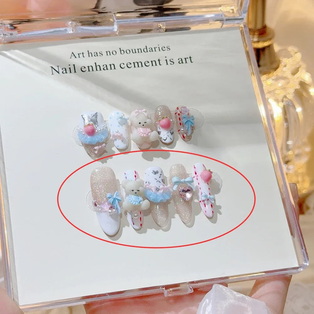 Decorated press-on nail sets with raised embellishments on display cards