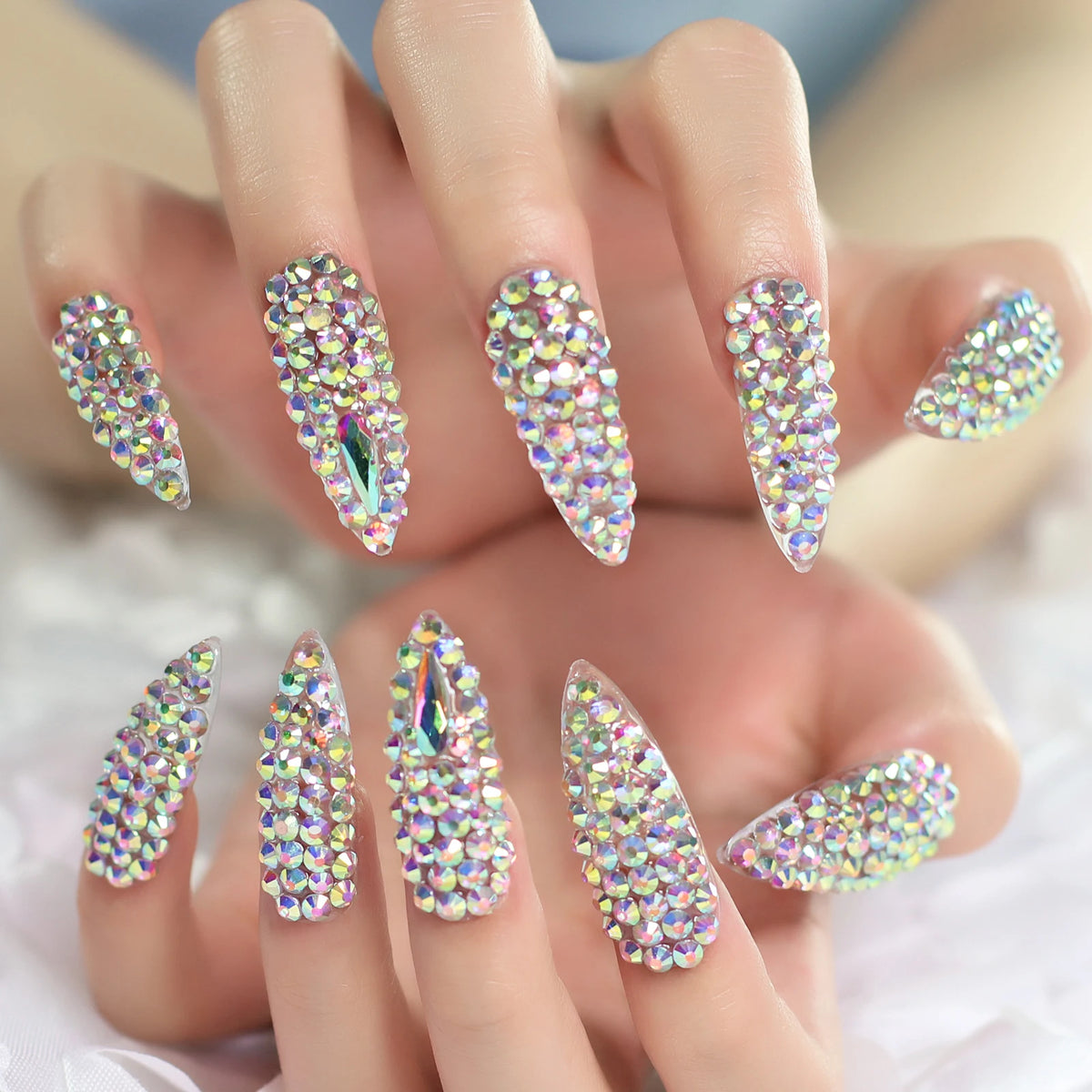Rhinestone-decorated nail designs shown on hands