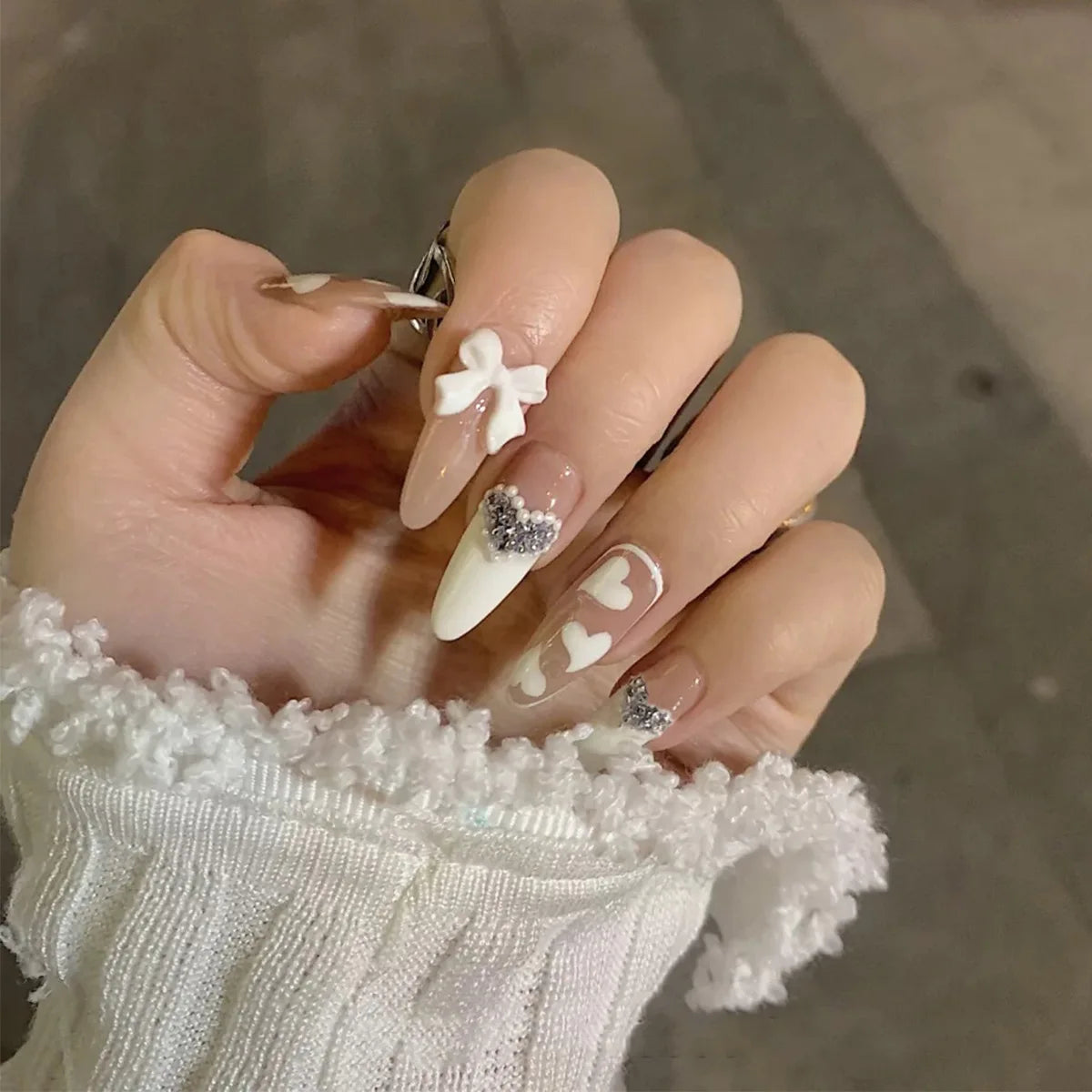 Decorated nail designs shown on hands
