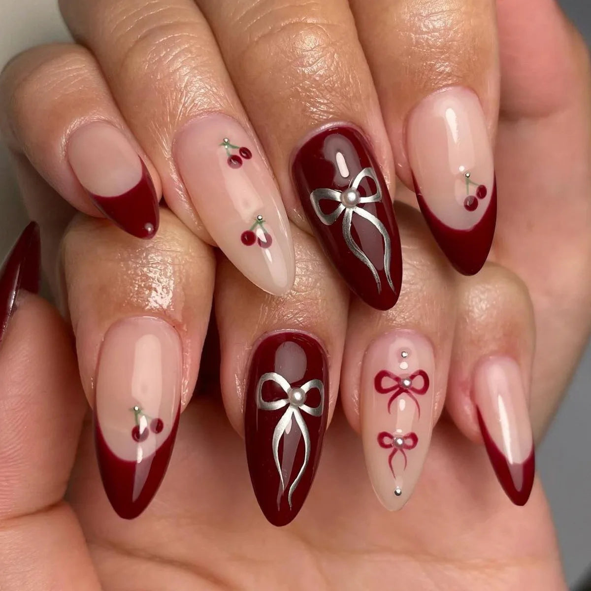 Long decorative nail designs with raised accents shown on hands
