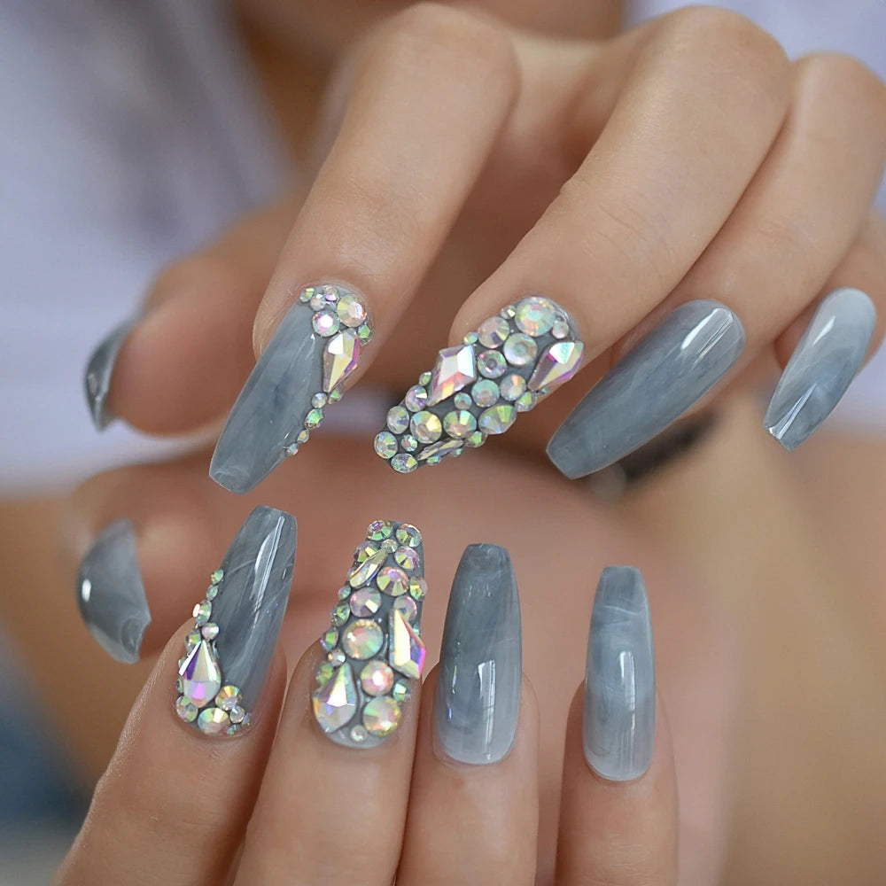 Rhinestone-decorated nail designs shown on hands