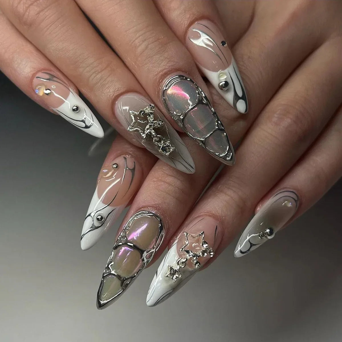Metallic and embellished nails shown on hands