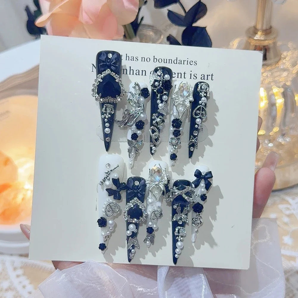Decorated press-on nail sets with raised embellishments on display cards