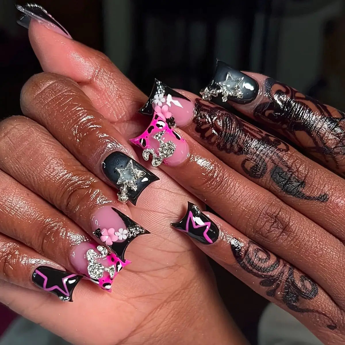 Decorative nail designs with raised accents shown on hands