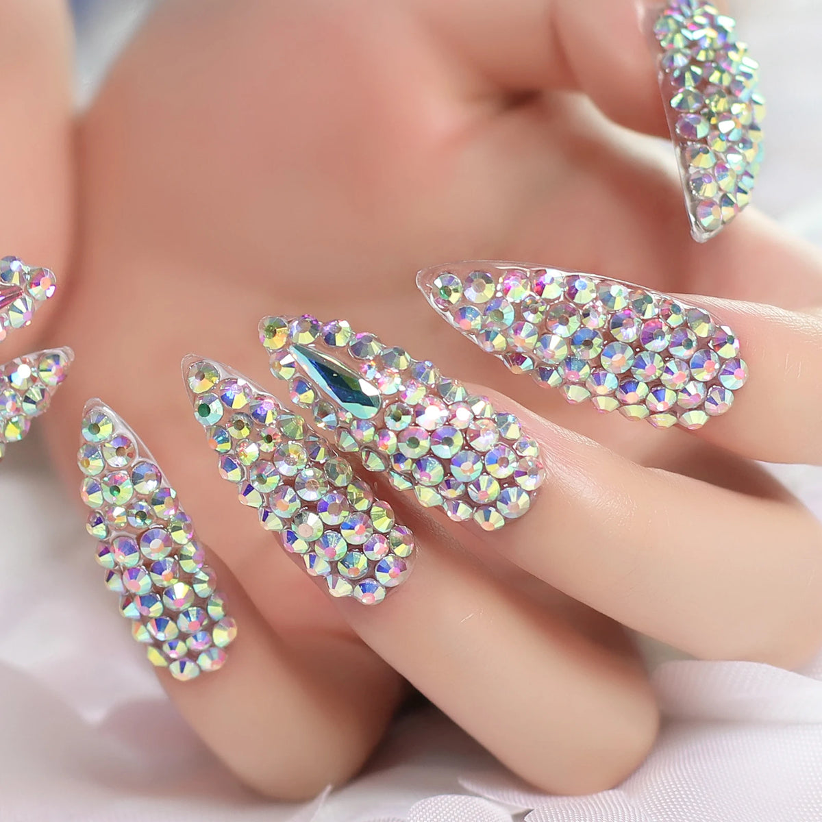 Rhinestone-decorated nail designs shown on hands