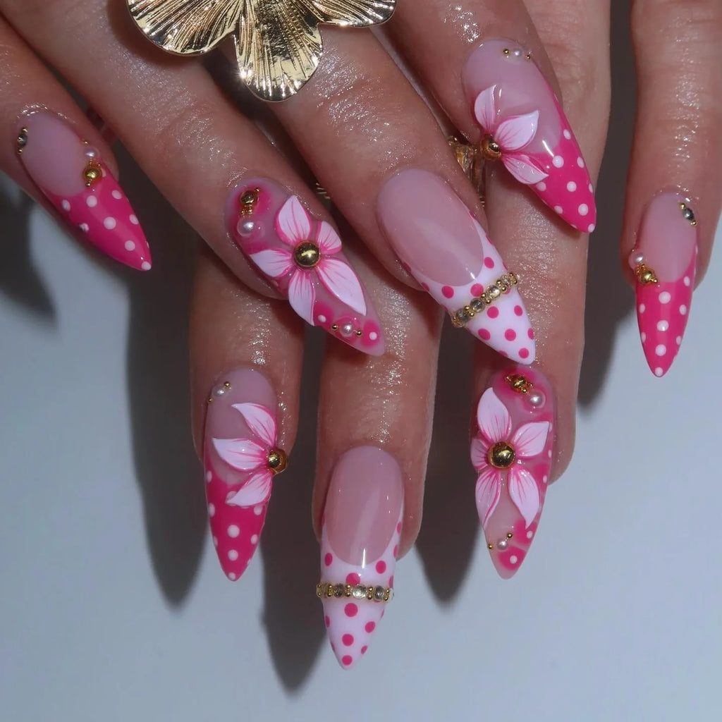 Pink floral pointed nails shown on hands