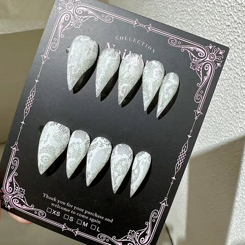 Decorated pointed press-on nails arranged in two rows