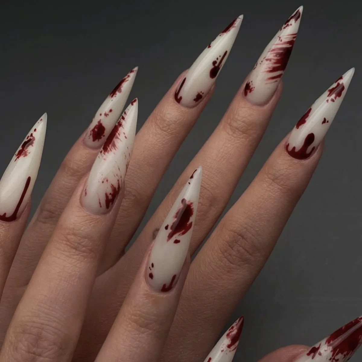 Long decorative nail designs with raised accents shown on hands