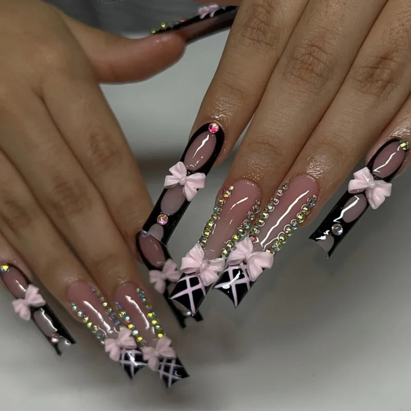 Long decorated nails with raised embellishments shown on hands